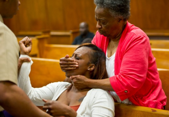 Patrice Lester, sister of Chassity Lester, is restrained by her brother Chad Lester and grandmother, Mae Helen Wright, after she yelled an obscenity at Brandon Davis as he left the courtroom. Davis plead guilty to fatally beating and stabbing the 26-year-old Lester.