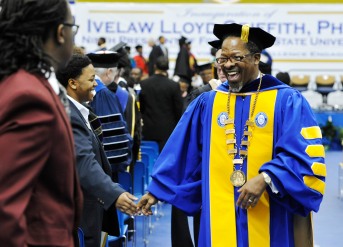 Fort Valley State University President Ivelaw Griffith, right, smiles and shakes hands with guests during the recessional after his investiture ceremonies at Fort Valley State University.